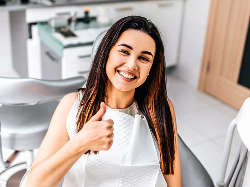 Happy dental patient in the dental clinic